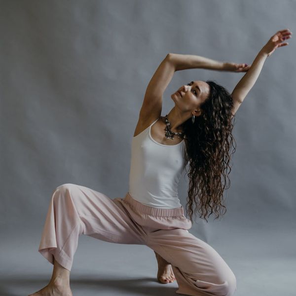 Person in a dynamic yoga flow pose, showing flexibility and strength.